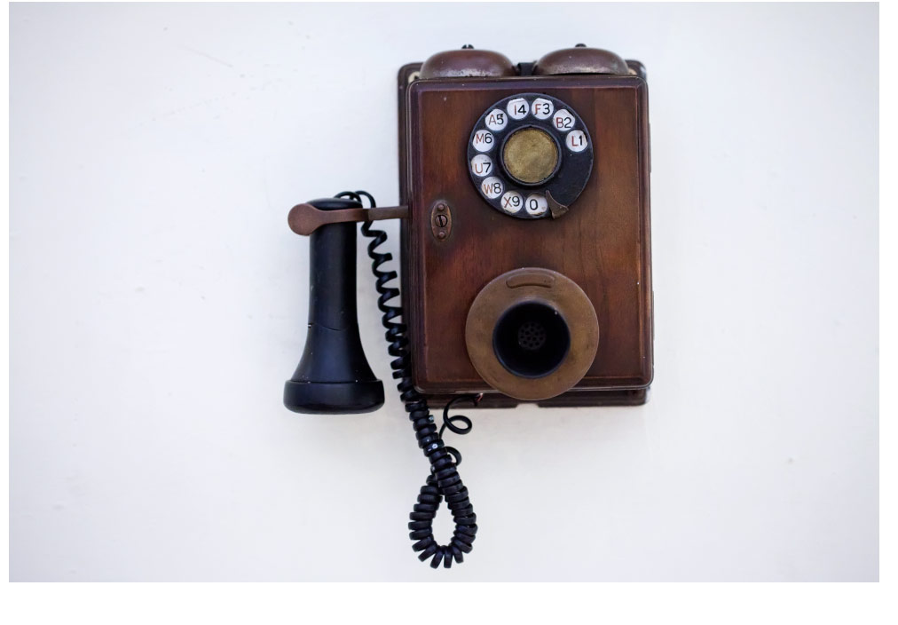 Vintage wooden wall telephone with rotary dial